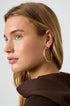 Astra Hoop Earrings: Gold-plated 18K gold PVD steel hoops on a woman's ear.