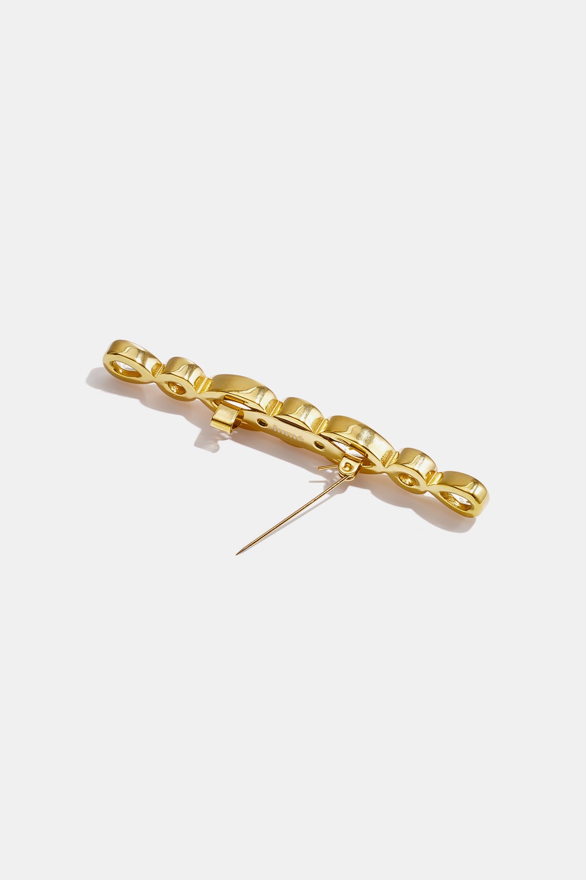 Gold-colored brooch with a linked droplet circle design and a pin closure.