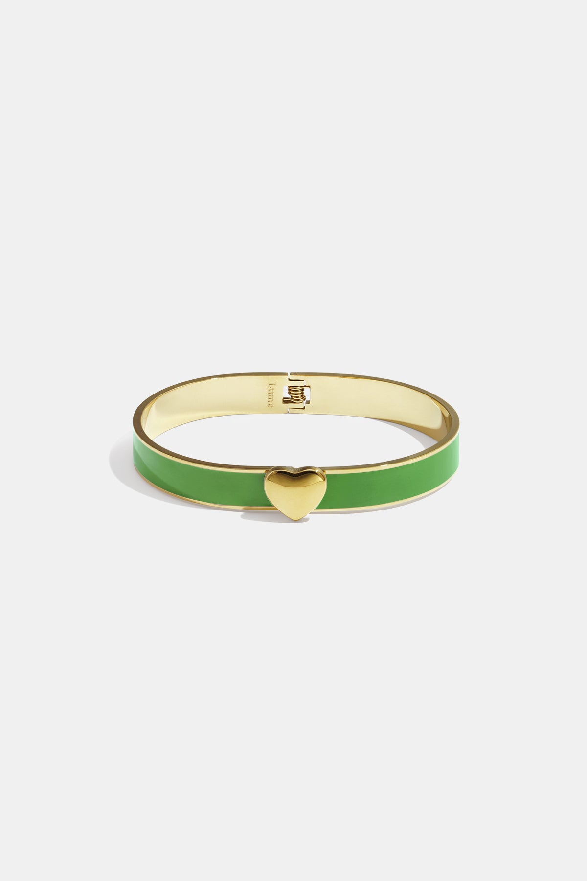 Gold bangle with green enamel and a gold heart charm.