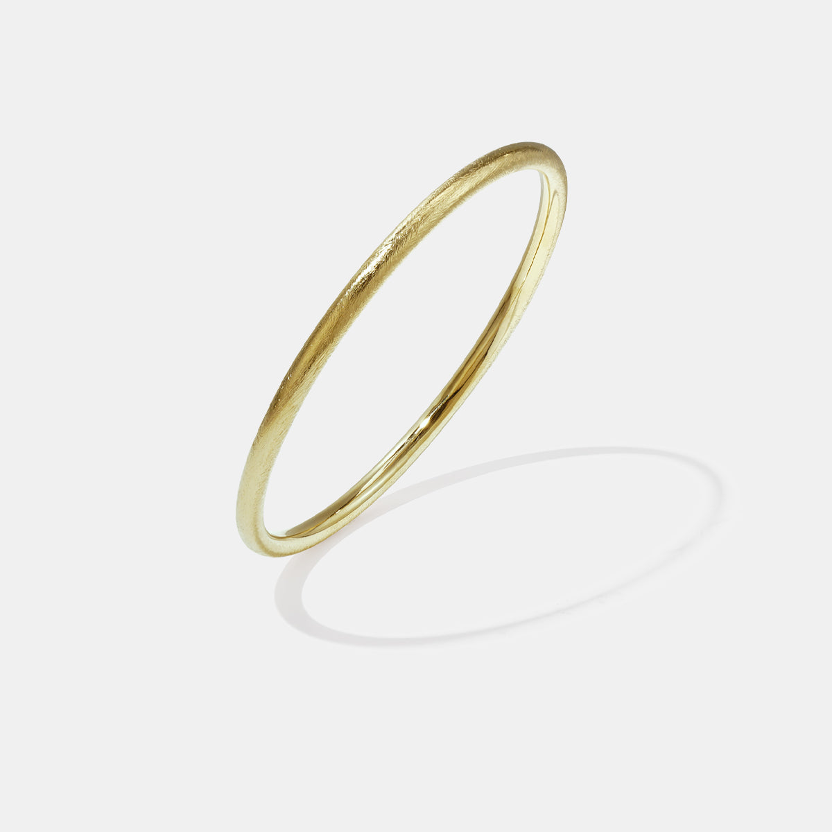 Gold Elara Bangle Bracelet with a brushed finish and 7 mm width.