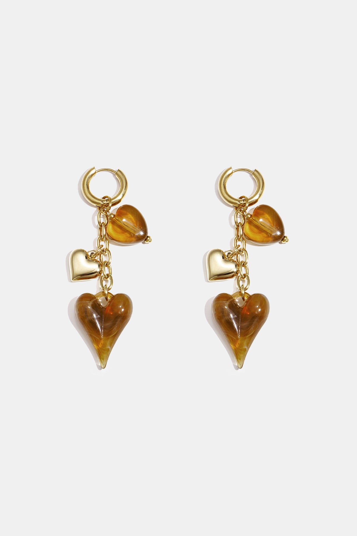 Gold hoop earrings with dangling amber and gold heart charms.