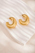 Gold Elysian Hoop Earrings with a brushed finish, displayed on a white wavy surface.