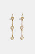 Gold dangle earrings with three heart-shaped zircon charms hanging from a bar.