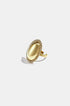 Gold-toned oval statement ring with a smooth, reflective surface surrounded by a halo of clear rhinestones.