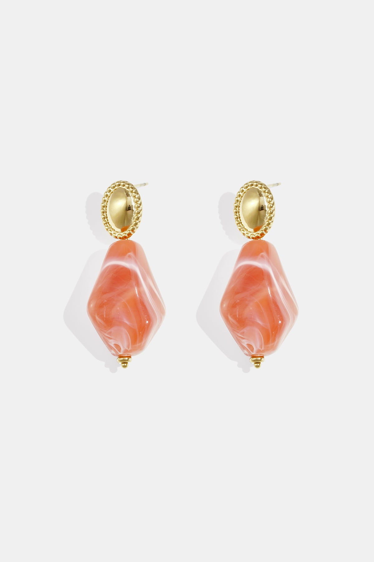 Pair of orange irregular diamond-shaped earrings with gold oval tops.