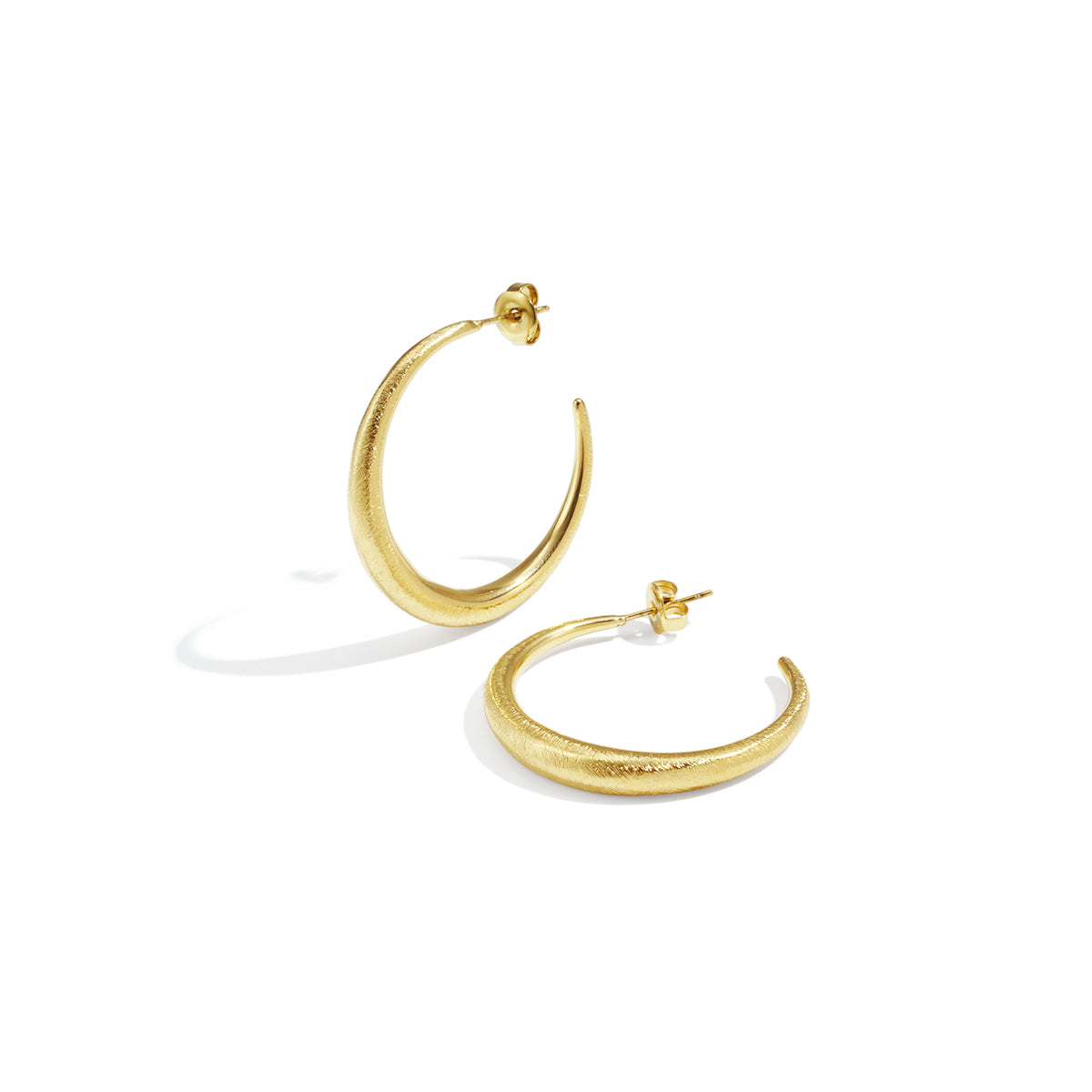 Aurelia Hoop Earrings: A pair of brushed gold-toned hoop earrings with stud backs.