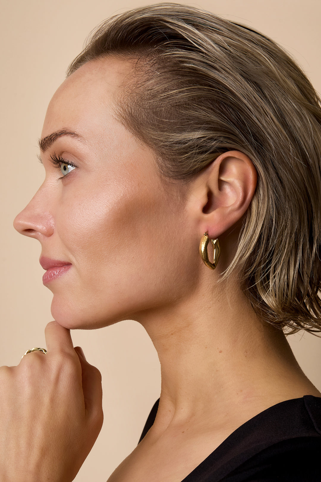 Aurelia Hoop Earrings: Gold-toned, heart-shaped hoop earrings with a shiny finish.
