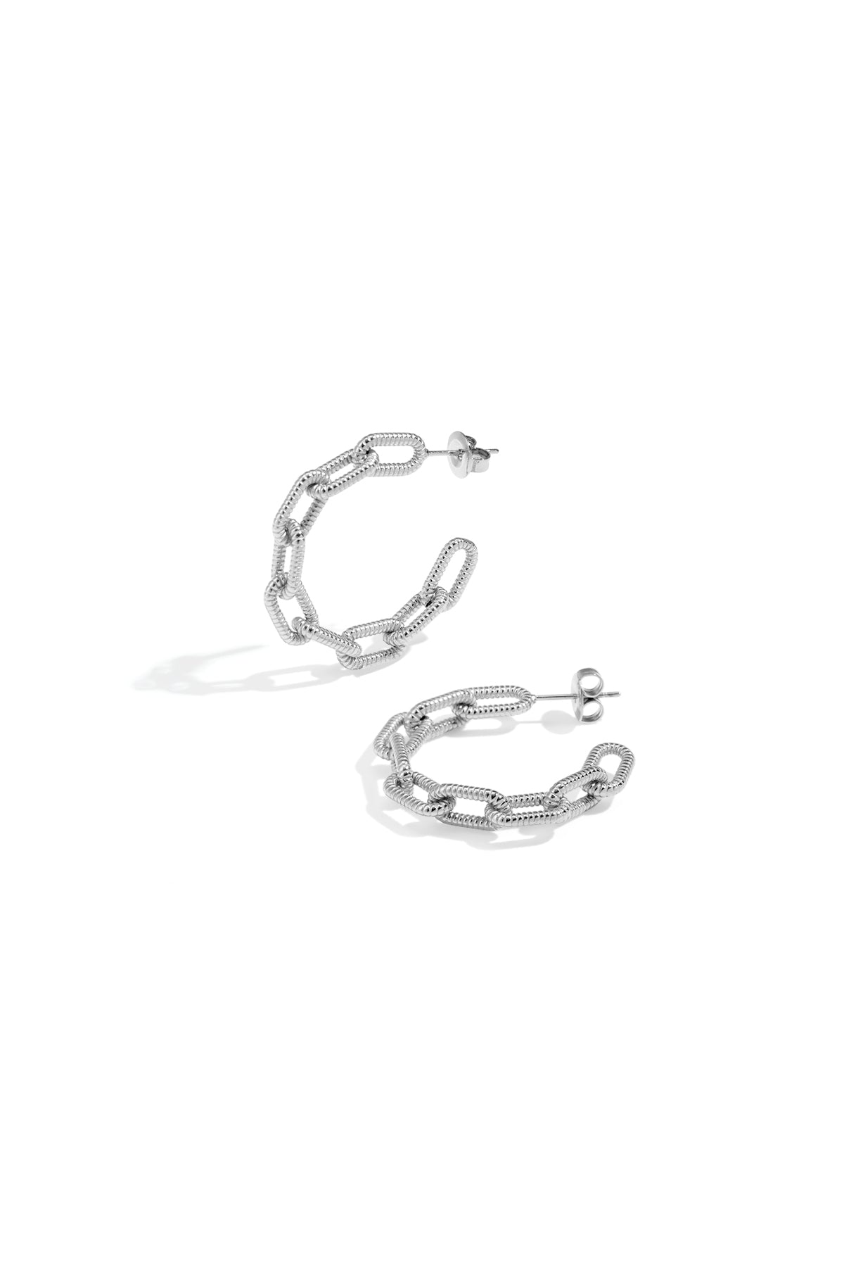 Silver chain link hoop earrings on a white background.