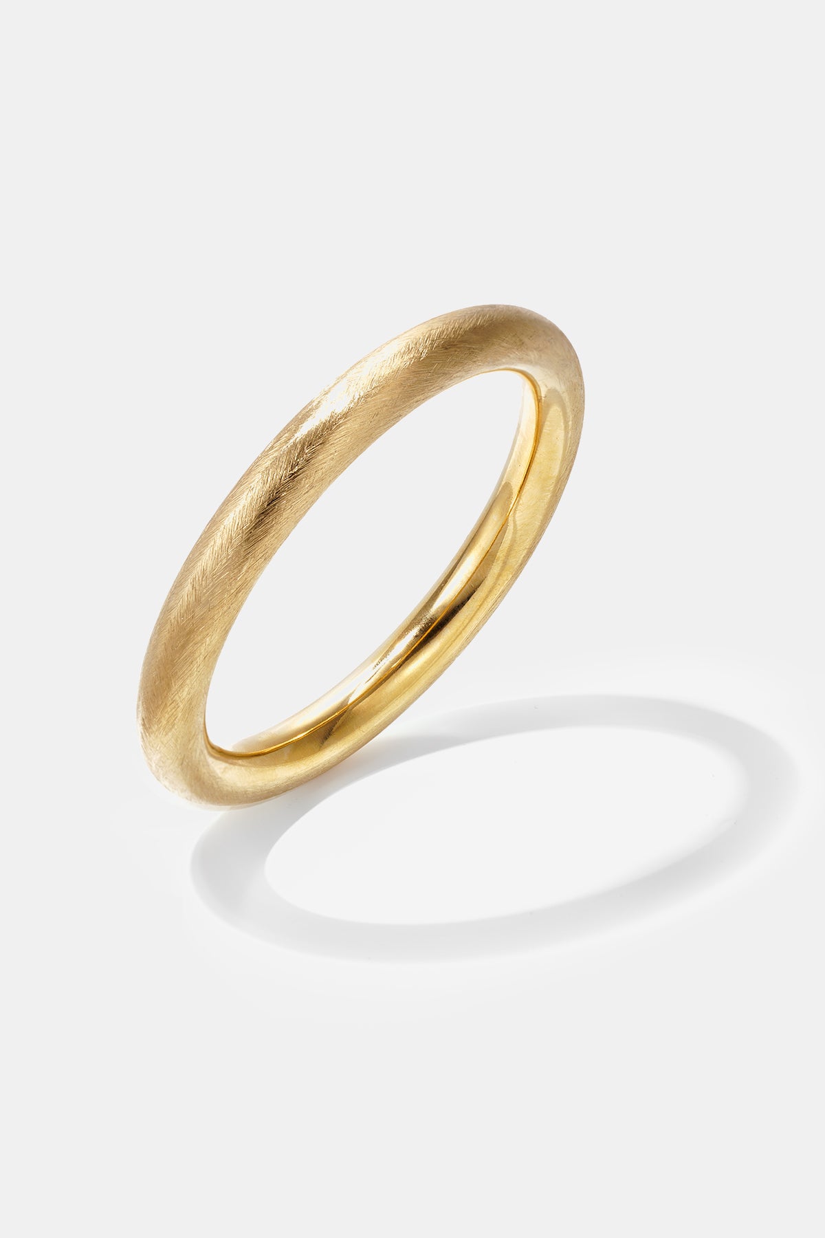 Elara Polished Bangle Bracelet in gold with a brushed finish.
