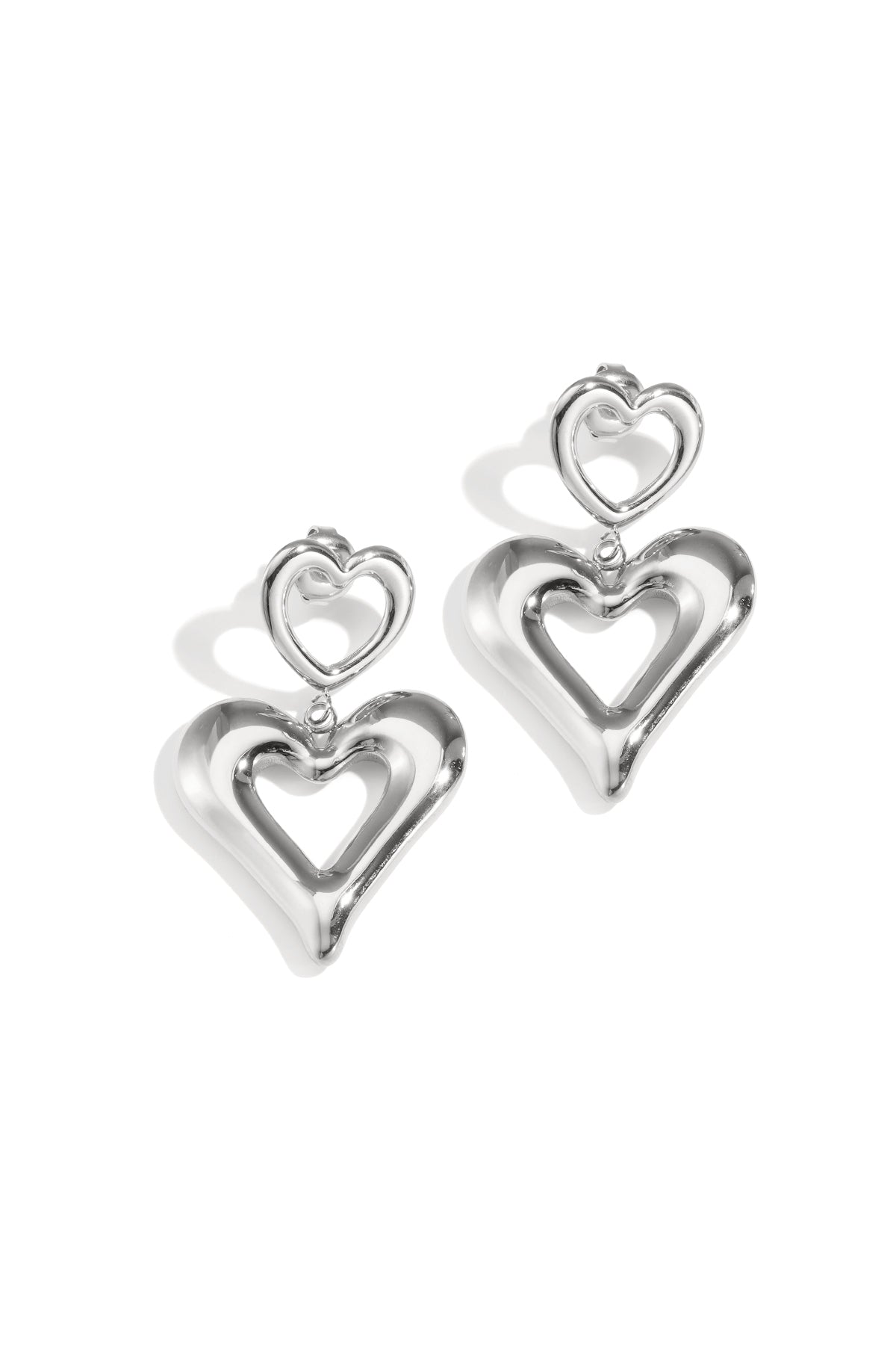 Silver heart drop earrings with a smaller heart stud.