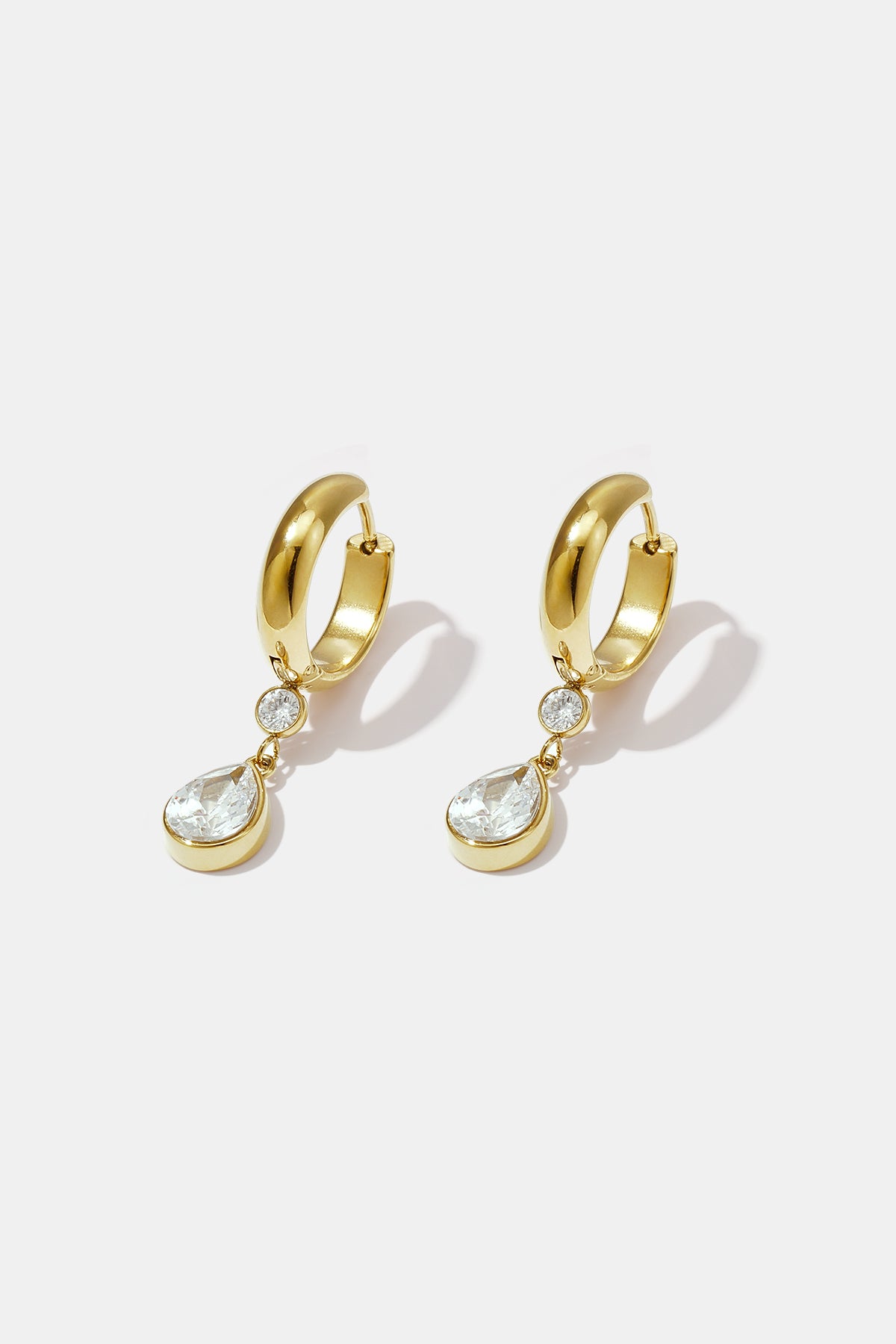 Gold hoop earrings with a pear-shaped zircon drop and a smaller round zircon above it.