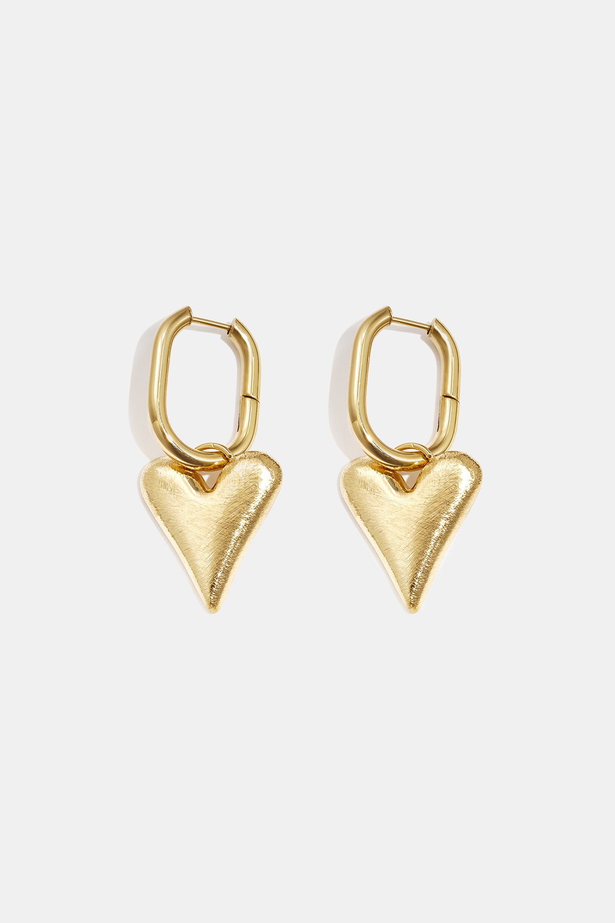 Gold heart drop earrings with oval hoops, brushed finish.