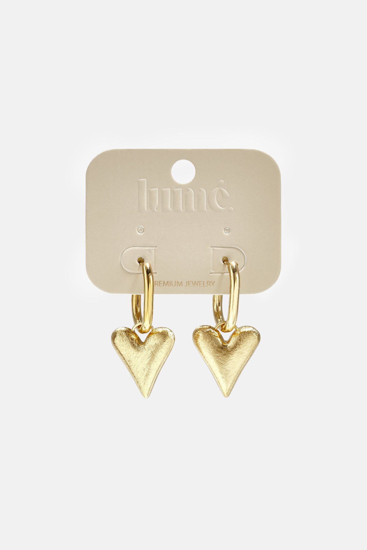 Gold heart drop earrings on a beige card with 'lume' and 'PREMIUM JEWELRY' printed on it.