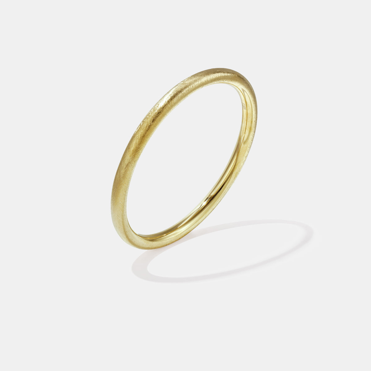 Elara Bangle Bracelet in gold with a brushed finish, 6 mm wide.
