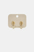 Gold heart drop earrings with zircon details on a beige card.