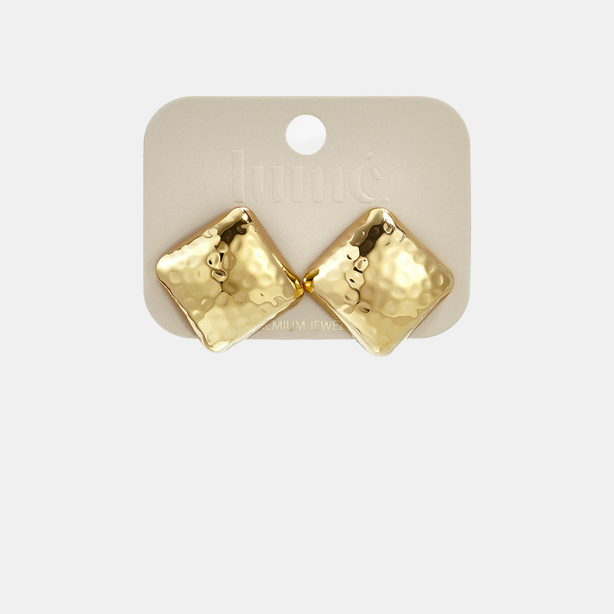 Gold square stud earrings with a hammered texture on a light beige card.