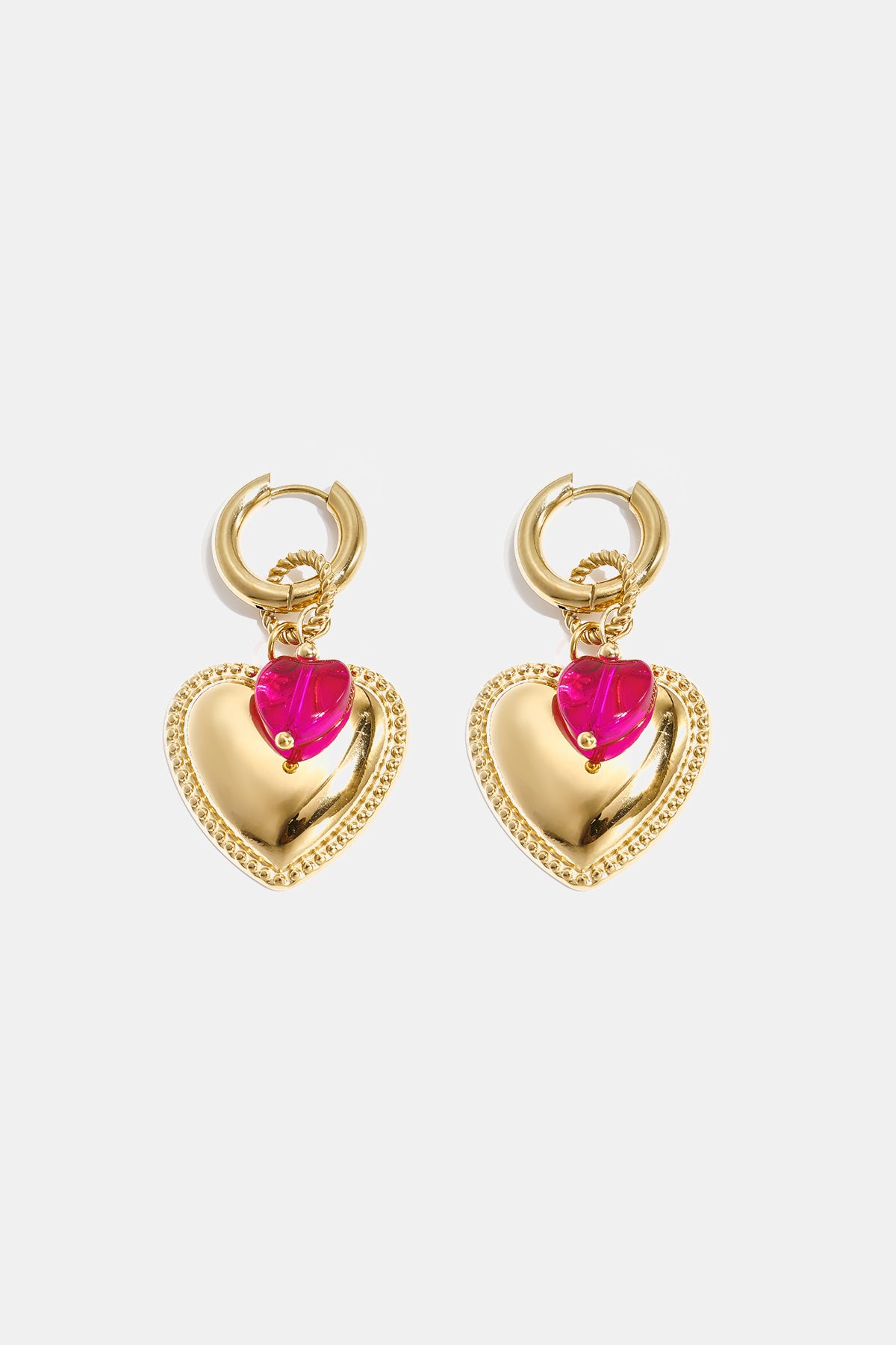 Gold heart hoop earrings with a pink heart bead accent.