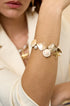 Ocean Charm Bracelet with shells, pearls, and starfish charms on a woman's arm.