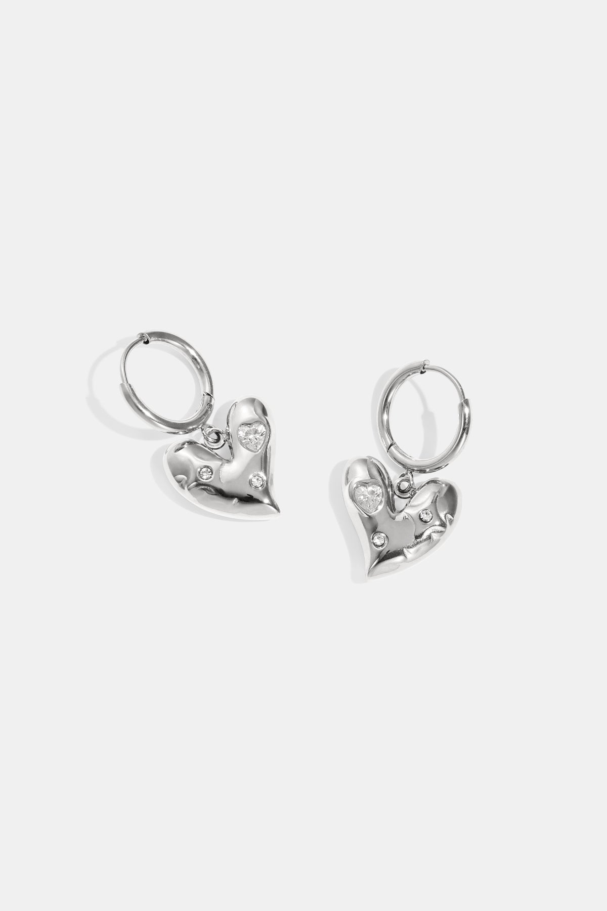 Silver heart drop earrings with rhinestones and loop fastening.