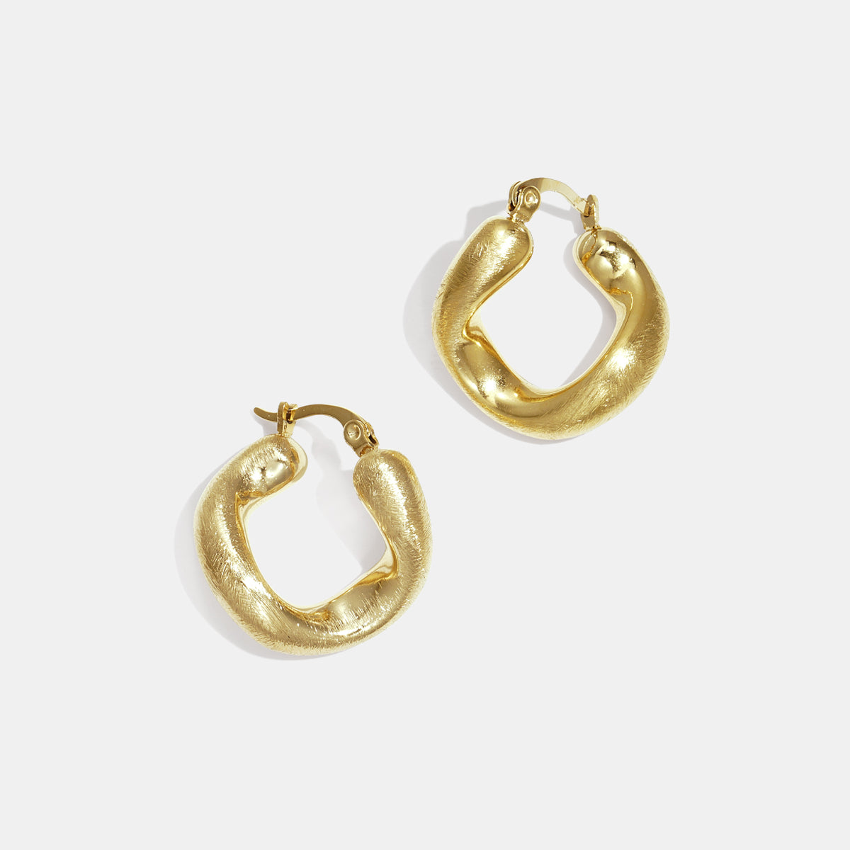 Gold irregular circle hoop earrings with a textured finish, shown against a white background.