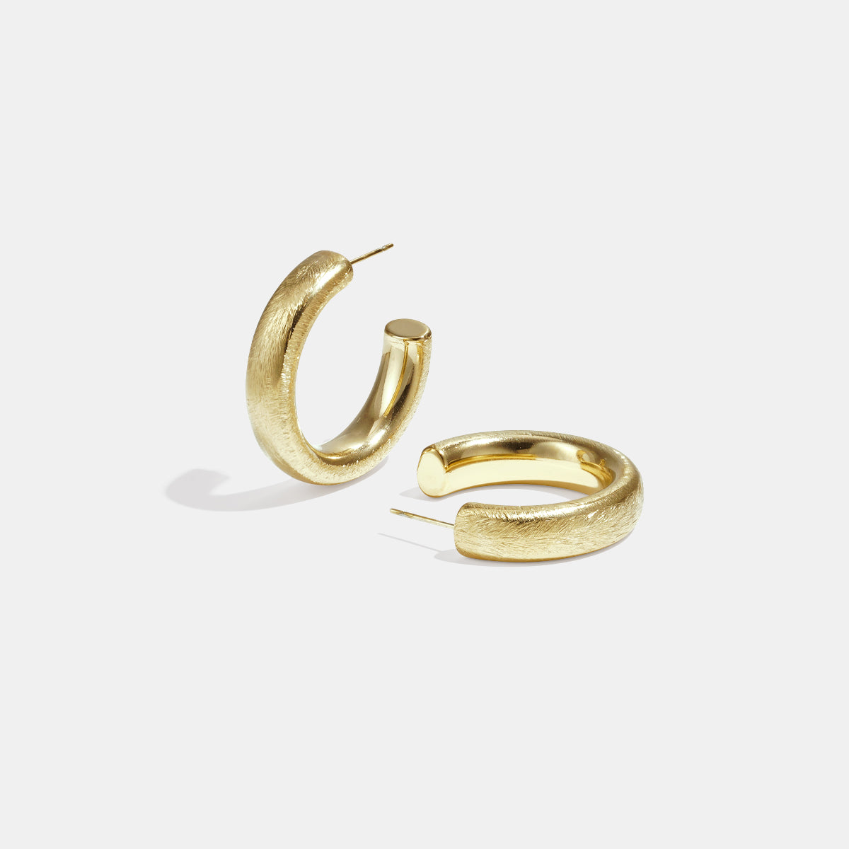 Aurelia Hoop Earrings in gold with a textured finish, displayed on a white background.
