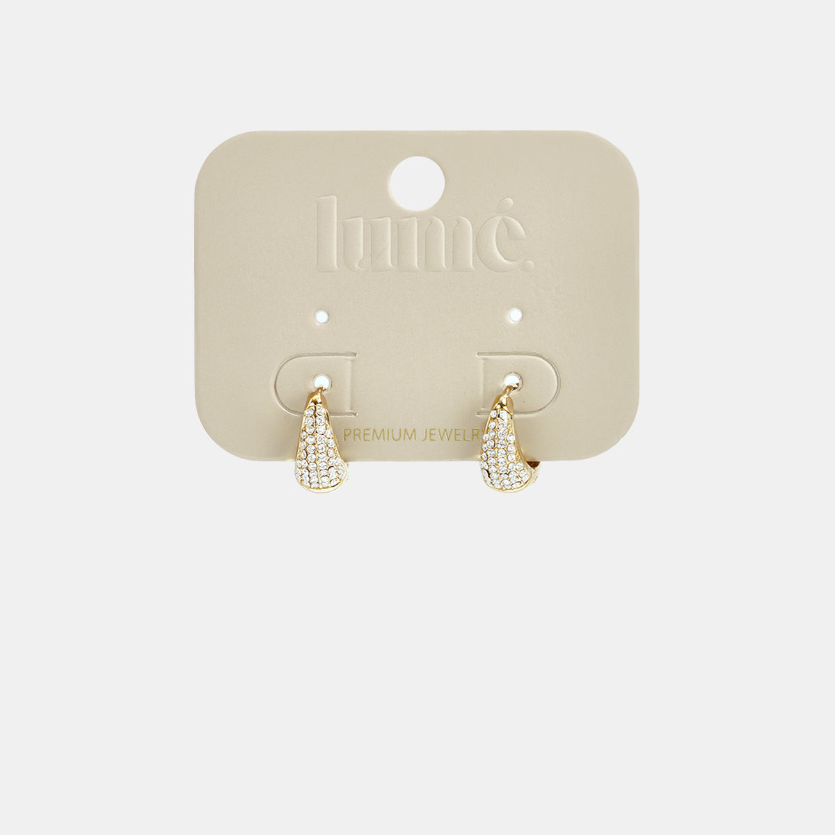 Gold hoop earrings with rhinestones on a beige card.