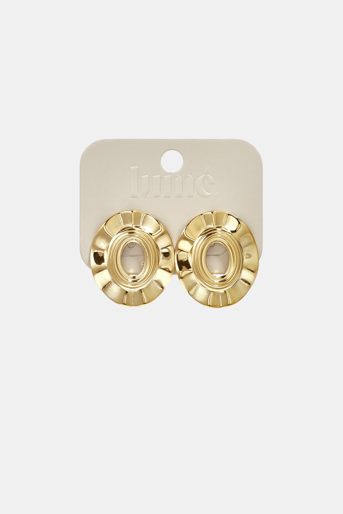 Gold irregular shape stud earrings with a textured circular design on a light beige card.