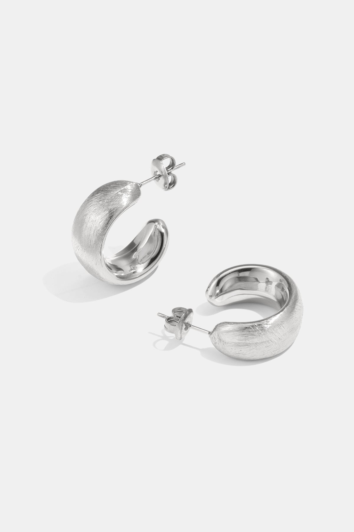 Pair of brushed silver-tone hoop earrings with post backs.