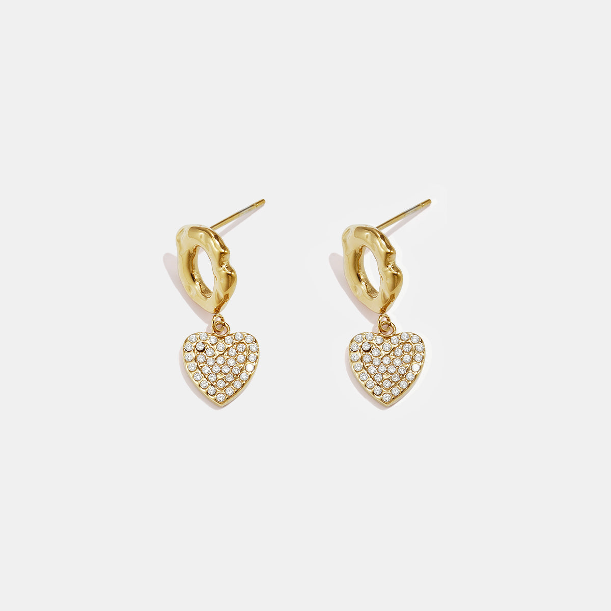 Gold heart drop earrings with clear stones and textured gold hoops.