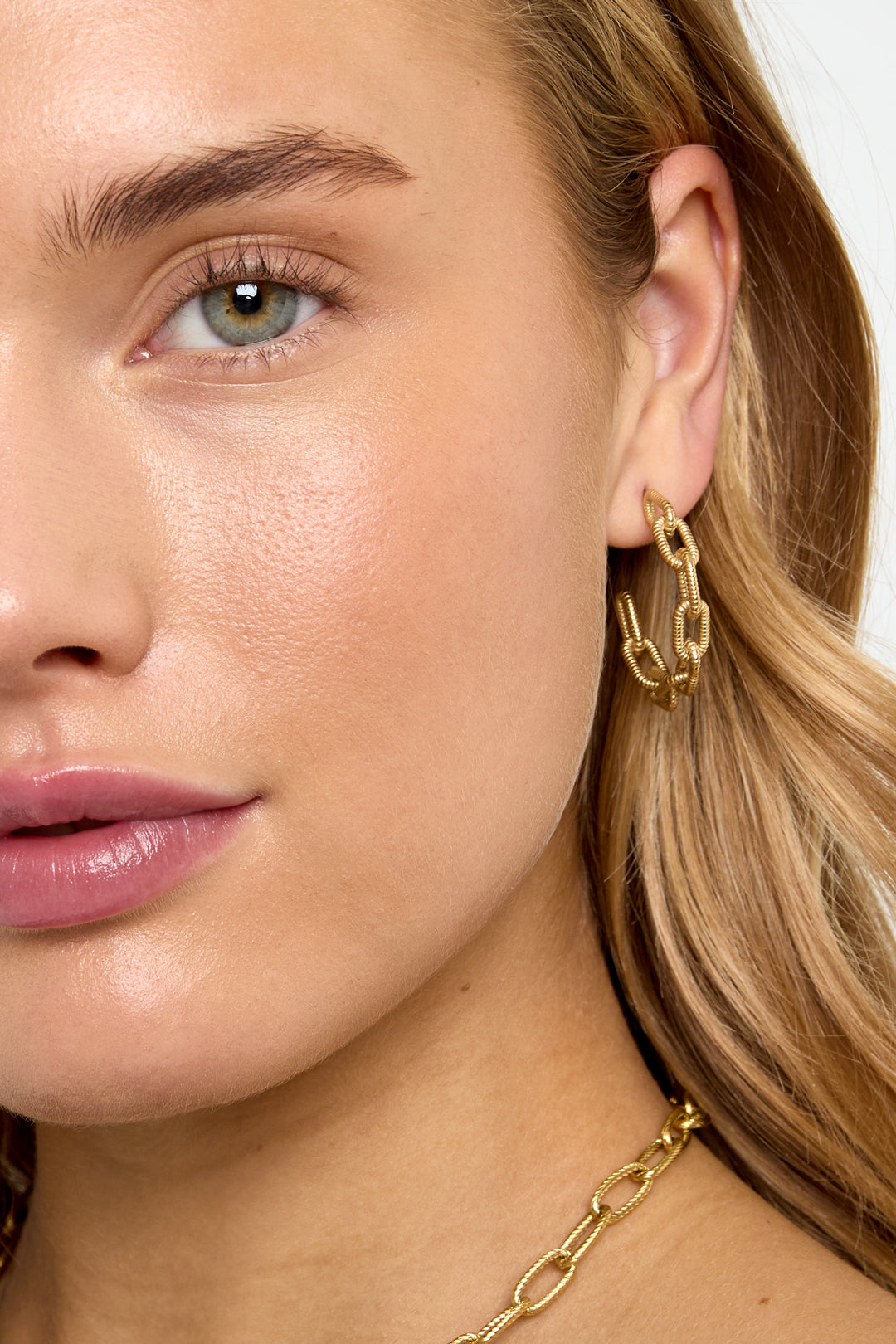 Gold Astra Hoop Earrings with a textured chain link design.