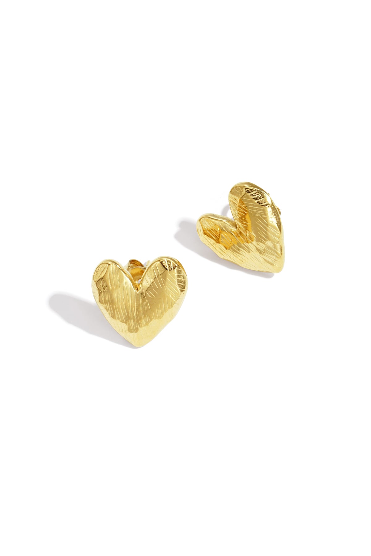 Gold heart-shaped stud earrings with a textured finish.