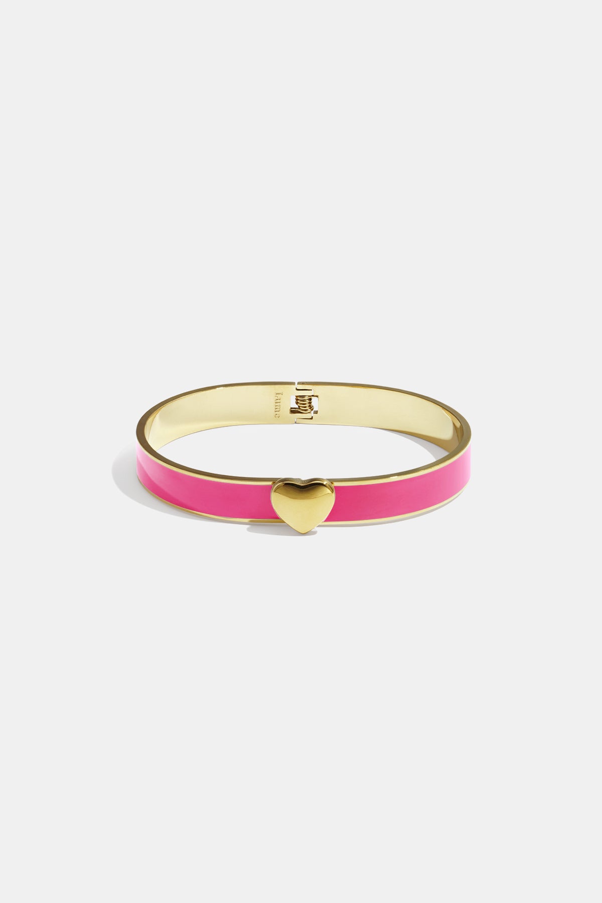 Gold bangle with pink enamel and a gold heart charm in the center.