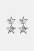 Silver celestial star drop earrings with textured surface.