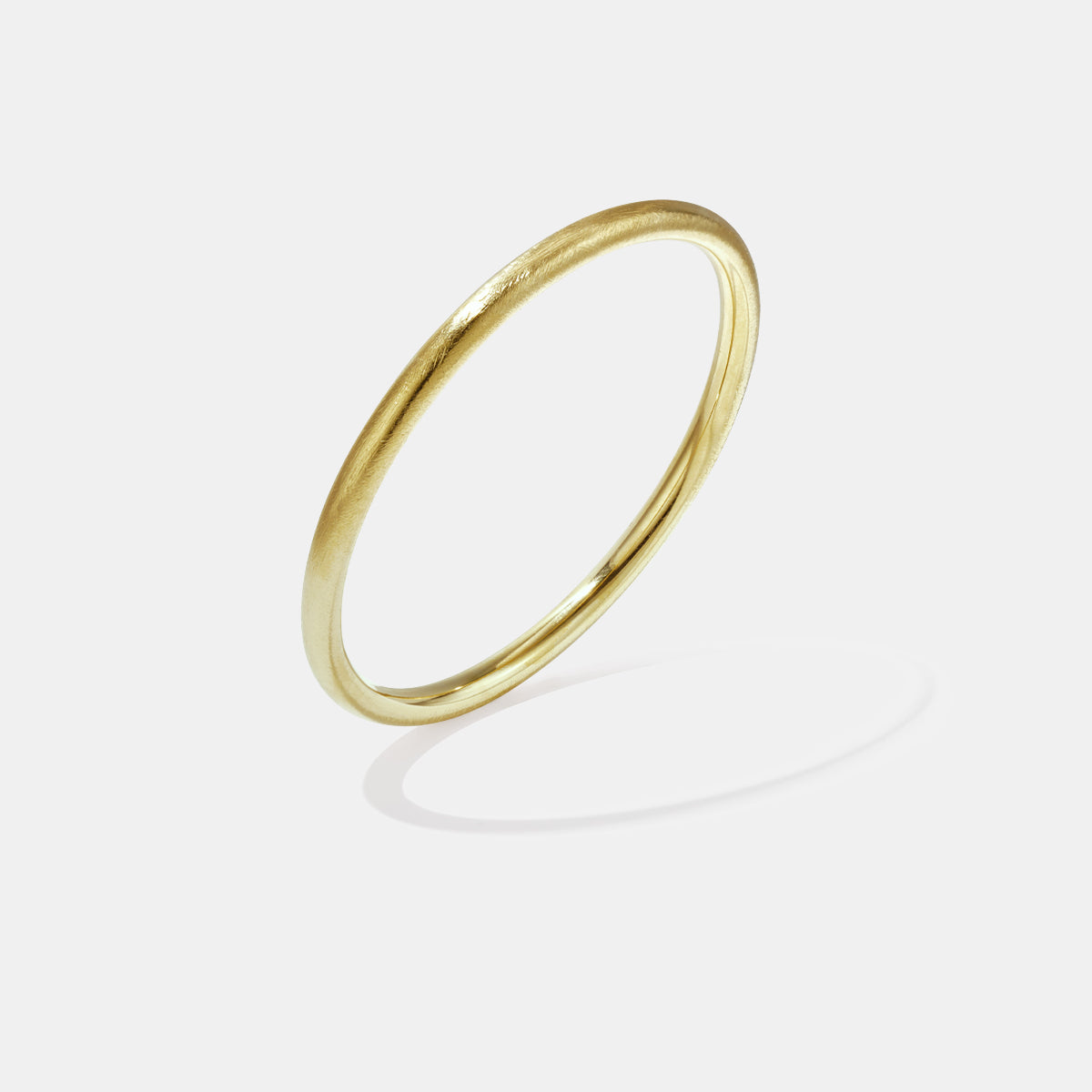 Elara Bangle Bracelet in gold, 5 mm wide with a brushed finish.