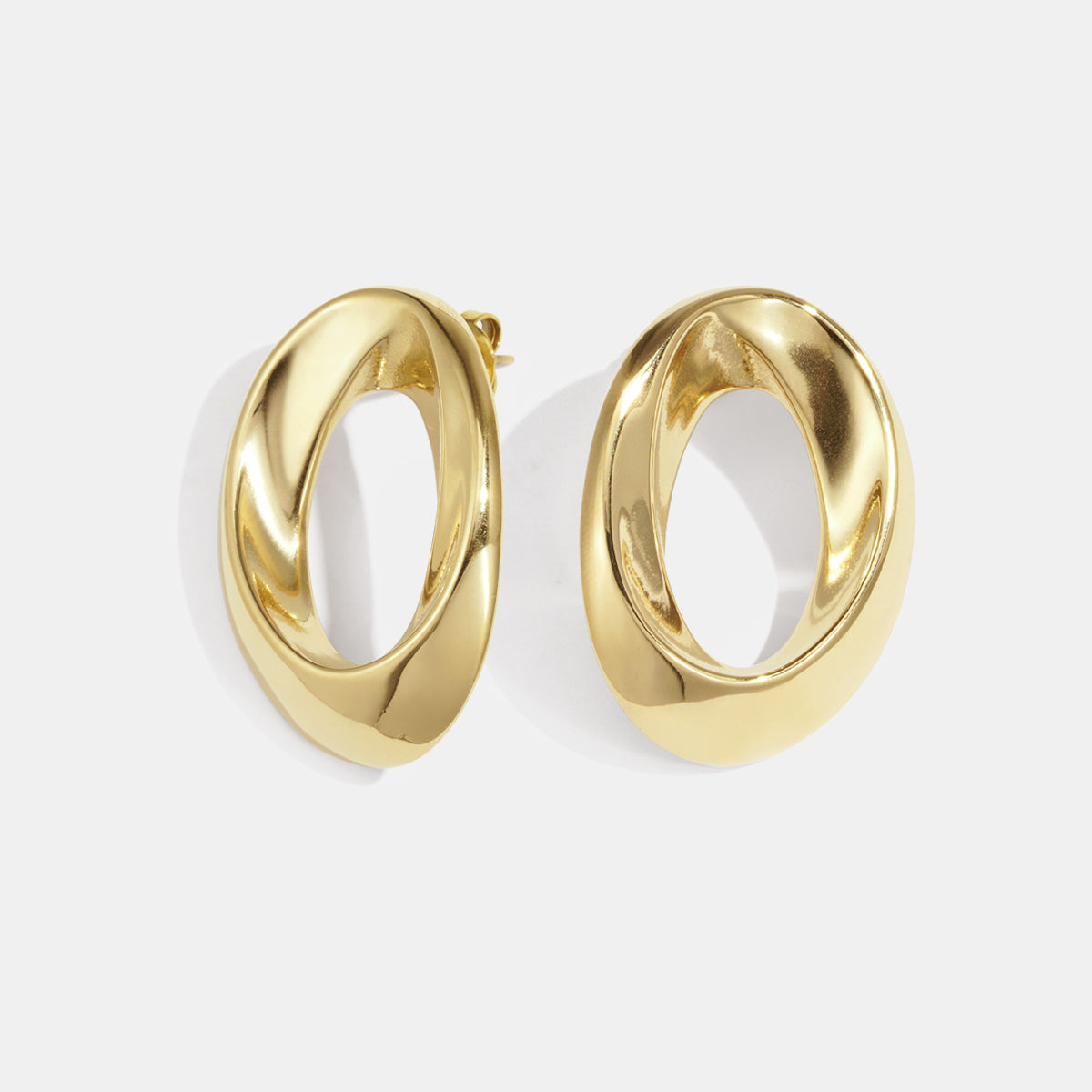 Gold-toned Aurelia Circle Stud Earrings with a twisted, oval shape.
