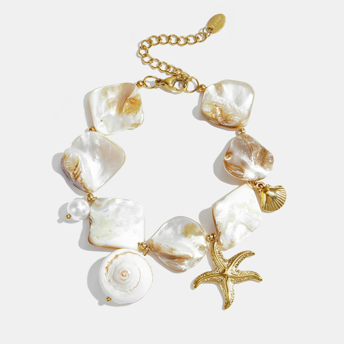 Ocean Charm Bracelet with shell, starfish, and pearl charms on a gold chain.