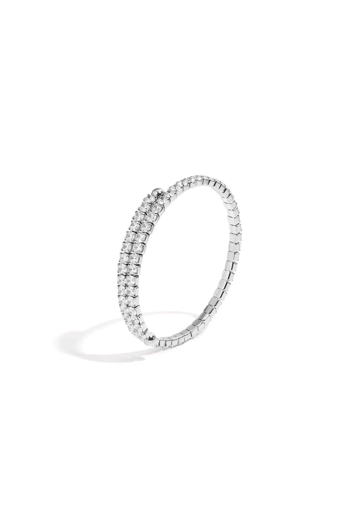 Silver cuff bracelet with two rows of clear rhinestones on a white background.