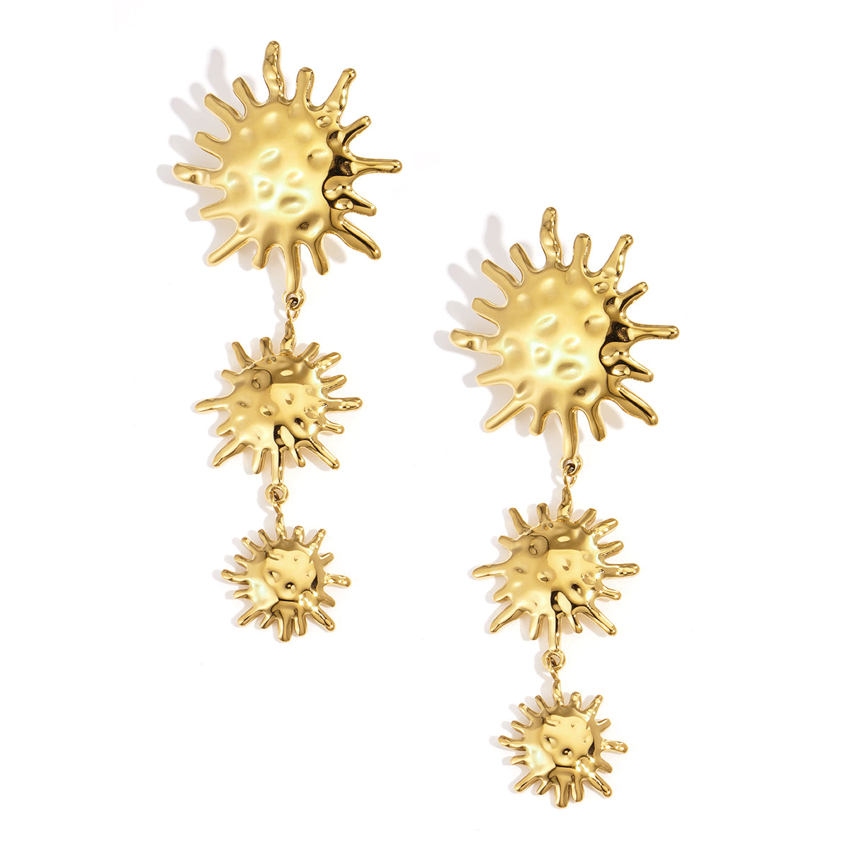 Gold dangle earrings with three sun motifs of decreasing size.
