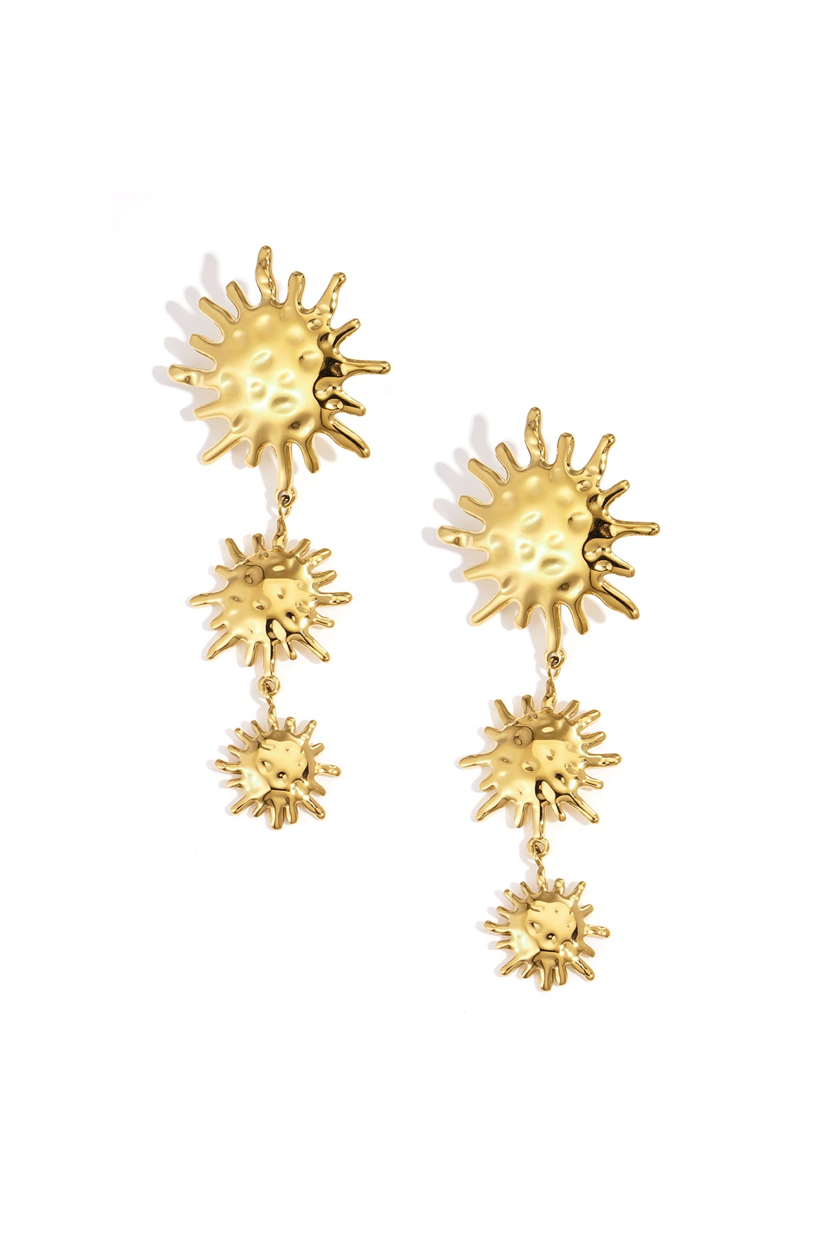 Gold dangle earrings with three sun motifs of decreasing size.