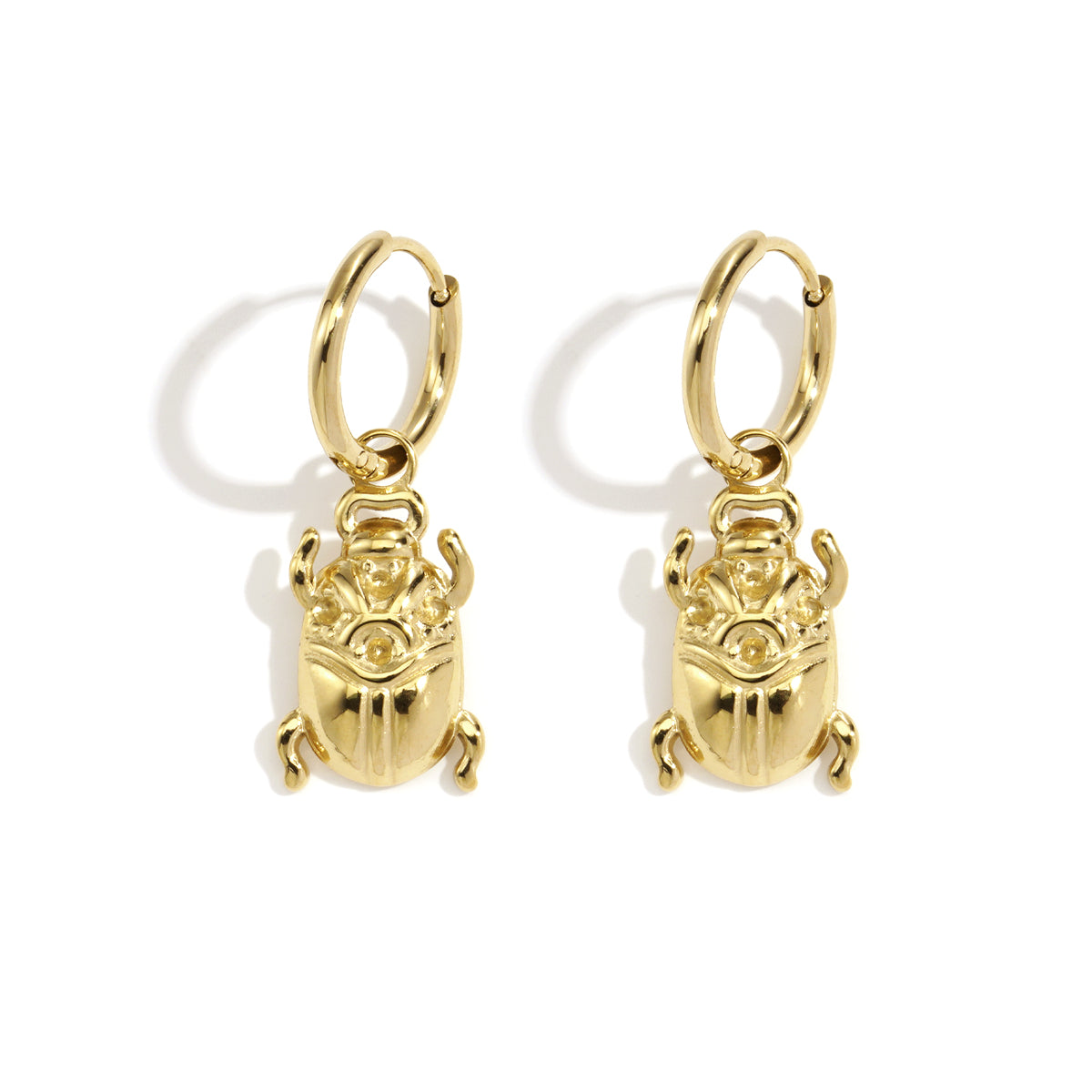 Gold-tone hoop earrings with dangling scarab beetle charms.