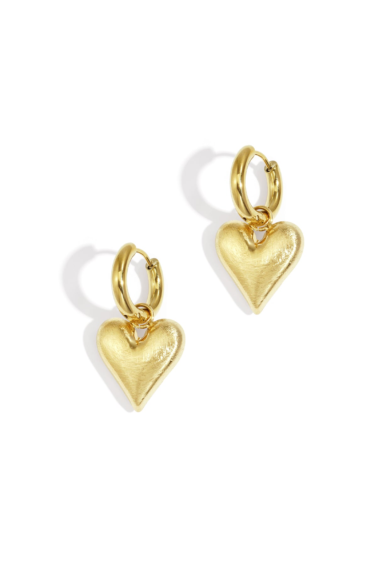 Gold heart drop earrings with a brushed finish on a white background.