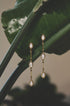 Celeste Dangle Earrings with three marquise-cut clear stones and gold-tone metal.