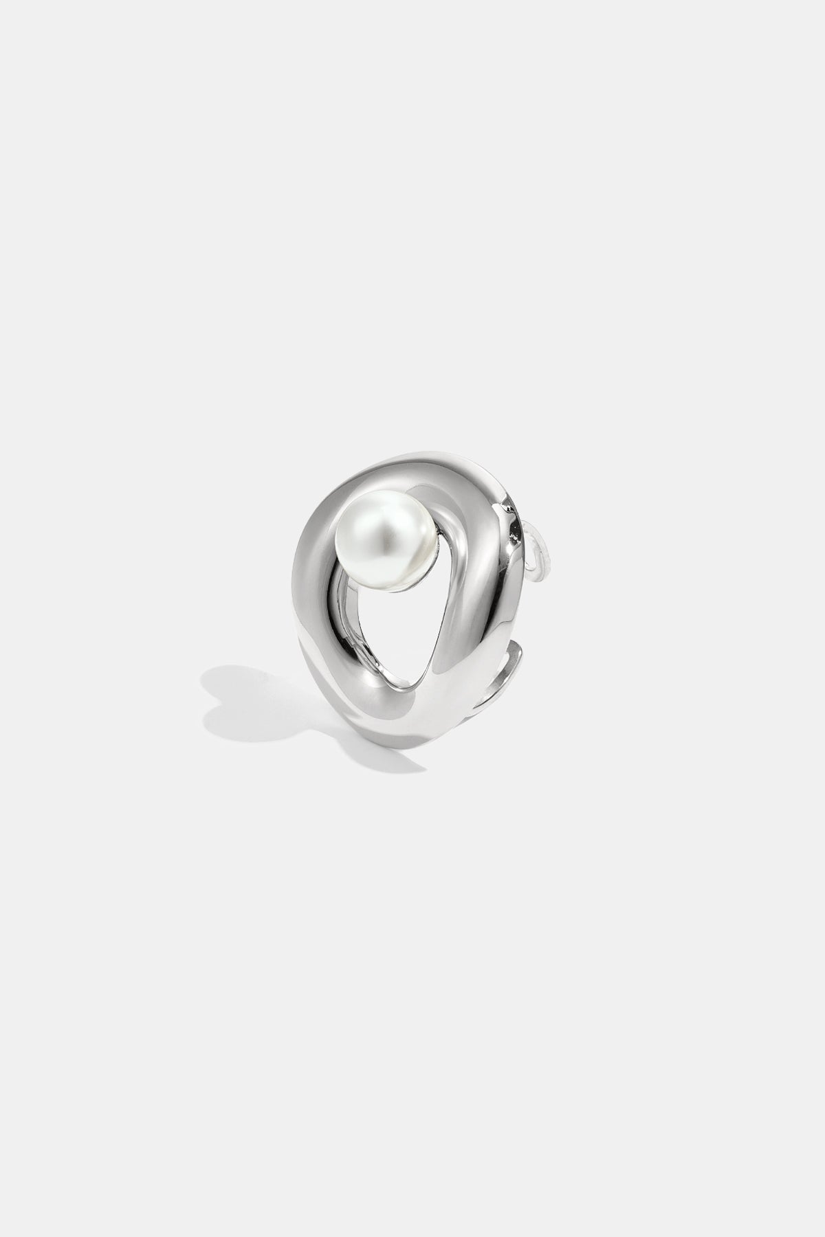 Adjustable gold-toned stainless steel ring with a pearl accent, featuring a circular design.